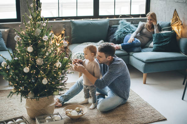 Father and daughter decorate a christmas tree | Great Floors